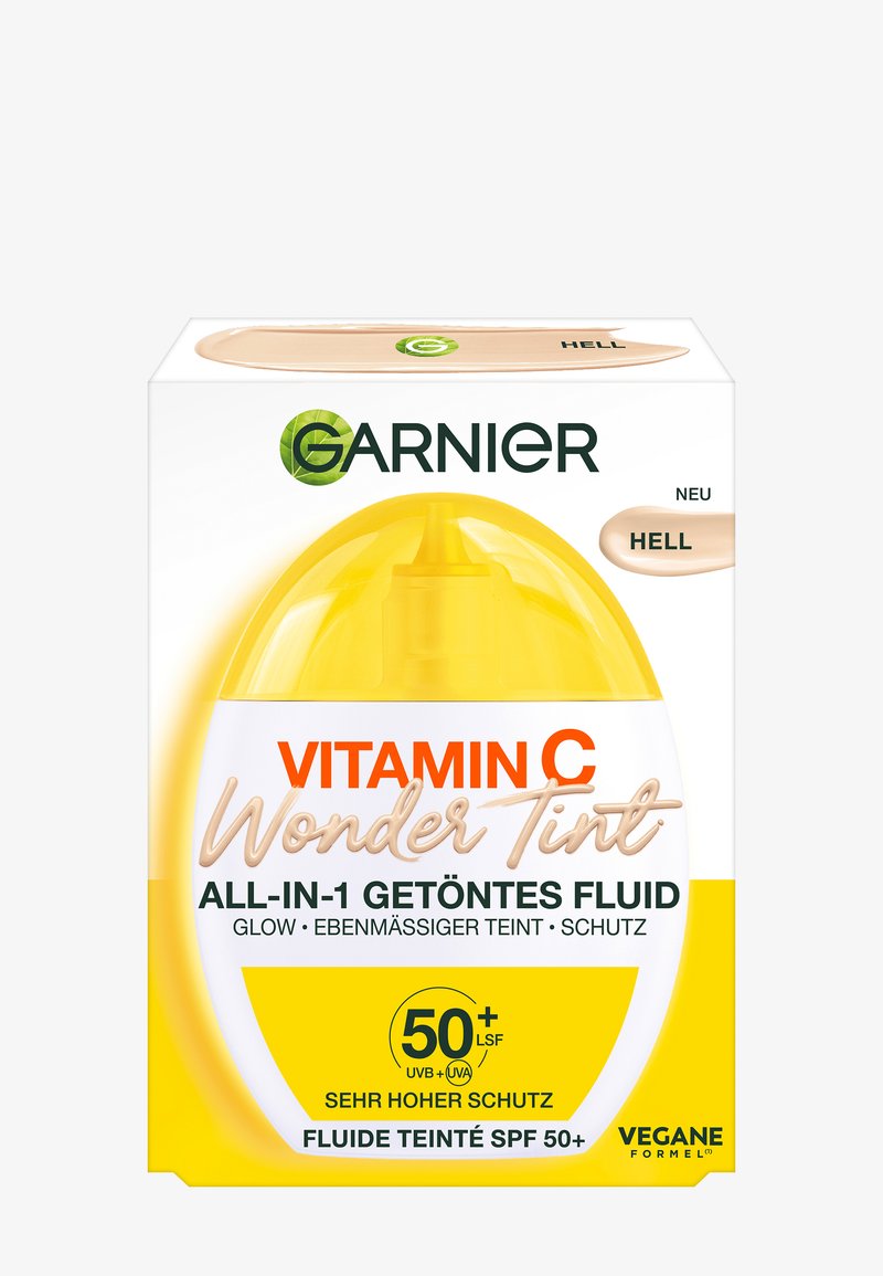 Verpakking van Garnier Vitamin C Wonder Tint, met een geel plastic flesje, wit-gele ontwerp, gelabeld met SPF 50+ en veganistische formule.