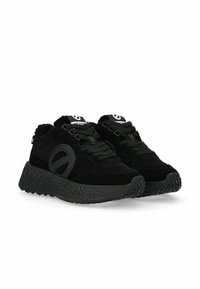 Black athletic shoes made of suede, featuring a textured rubber sole, rounded shape, and a prominent logo detail on the side.