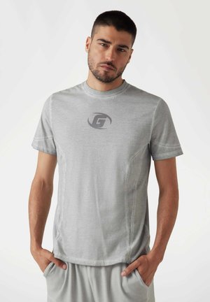 Gray short-sleeve t-shirt made of smooth fabric, featuring a logo in the center, with visible stitching details and a crew neckline.