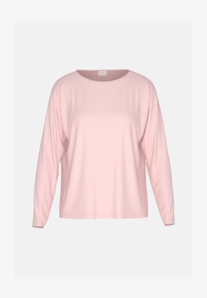 Lichtroze top met lange mouwen gemaakt van zachte stof. Heeft een ronde hals, doorgezakte schouders, een losse pasvorm en minimale naden.