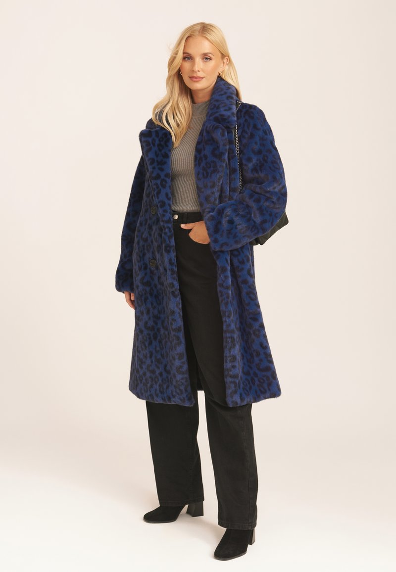 Long blue leopard print coat with a plush texture, featuring a high collar and two front buttons. Worn over a gray top and black pants.