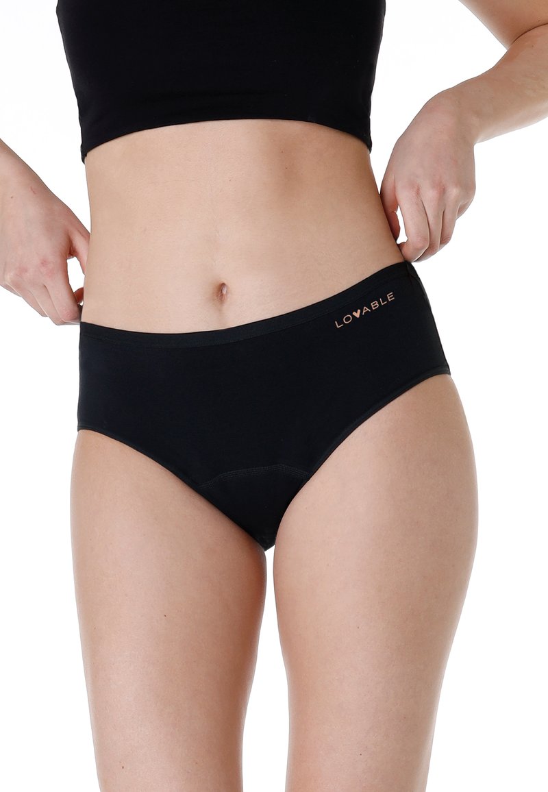 Slipping bikini in cotone nero con un girovita liscio. Presenta un logo sottile in rame e un design senza cuciture per il massimo comfort.