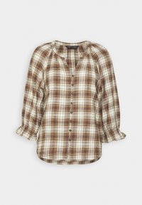 Brun och creamrutig skjorta med rundad halsringning, trekvartslånga ärmar och knäppning framtill. Har volangdetalj vid axeln.