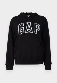 Black hooded sweatshirt with a front kangaroo pocket, featuring "GAP" in large white letters. Soft fabric and ribbed cuffs.