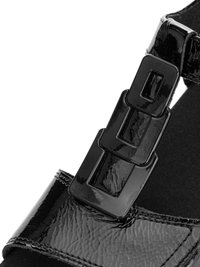 Black patent leather shoe strap with three rectangular glossy buckles and visible stitching on a black sole.