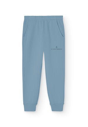 Ljusblåa sweatpants med elastisk midja, sidofickor och en liten tryckt logotyp på framsidan. Tillverkade av ett mjukt och slätt material.