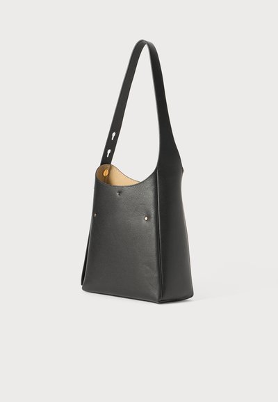 Black leather shoulder bag with a slim design, curved top, gold-tone hardware accents, and smooth texture. Features a single long strap.