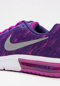 Tenisky Nike Air Max s fialovým síťovaným svrškem a růžovými akcenty, vybavené šedým logem, bílou mezipodešví a viditelnou vzduchovou zásadou.