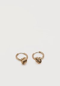 Ζευγάρι μικρών χρυσών κρίκων με λεπτομέρεια σε στριφτό κόμπο σε απλό λευκό φόντο.