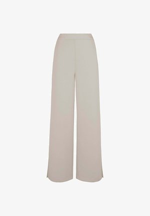 Helle beige, weit geschnittene Hose mit elastischem Bund, weicher Textur und Schlitzen am Saum für zusätzlichen Bewegungsspielraum. Lässiges und komfortables Design.