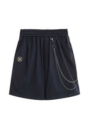 Pantalones cortos negros con cintura elástica, bolsillos laterales, cadena decorativa plateada en el lado derecho y un pequeño parche circular en el lado izquierdo.