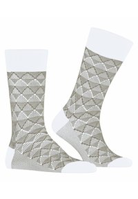 Beige gemusterte Socken mit weißen Akzenten, die ein geometrisches Design aufweisen. Gerippter Bund und verstärkte Ferse, weiche Textur mit glatter Oberfläche.