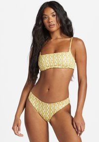 Yellow bikini set with a geometric pattern, featuring a bandeau top and high-waisted bottom, smooth fabric, and thin straps.