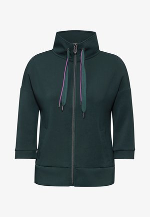 Ciemnozielona bluza z zamkiem błyskawicznym, z wysokim kołnierzem, krótkimi rękawami, fioletowymi i turkusowymi sznurkami do ściągania oraz dwiema przednimi kieszeniami. Gładka faktura materiału.