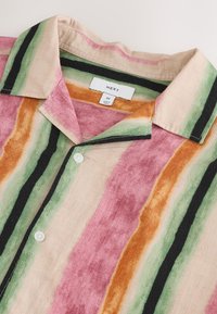 Chemise boutonnée multicolore avec des rayures horizontales en rose, vert, noir et orange. Fabriquée dans un tissu à texture subtile.