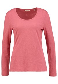 Långärmad rosa t-shirt i lättviktig tyg med rund halsringning, med en något texturerad yta och sidslitzar vid nederkanten.