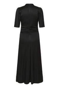 Black dress with a textured pattern, short puff sleeves, and a ruched back. Flows down to a slightly flared hem.