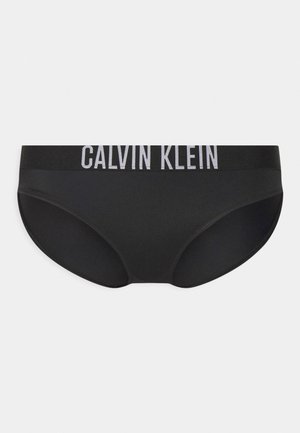 Culottes en coton noir avec une texture lisse, dotées d'une large ceinture élastique imprimée avec "CALVIN KLEIN" en lettres blanches contrastées.