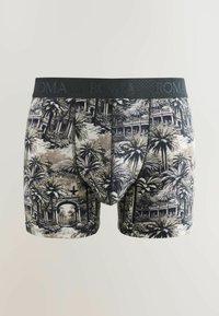 Slip noir et beige avec imprimé palmiers et arche, ceinture noire avec un branding subtil "ROMA".