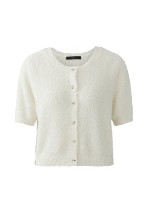 Kortärmelig, crèmekleurige textuurvest met ronde halslijn en knopen aan de voorkant, met het label "oui" aan de binnenkant van de kraag.