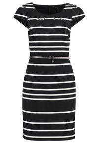 Robe noire à rayures horizontales blanches, manches courtes, encolure ronde, et une ceinture noire fine à la taille avec un petit pendentif.