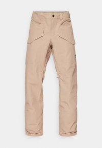 Pantalons cargo beige clair en tissu résistant à l'eau, dotés de plusieurs poches, de genoux renforcés et d'une jambe inférieure zippée pour un ajustement.