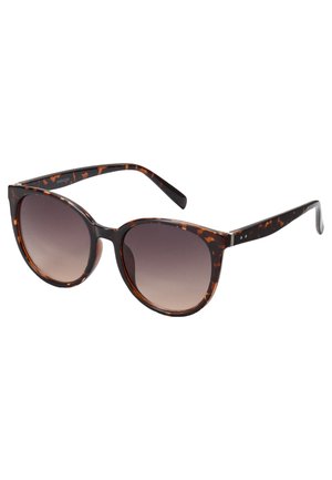 Tortoiseshell sunglasses with large rounded frames, gradient lenses, and smooth black arms featuring subtle accents and metallic hardware.