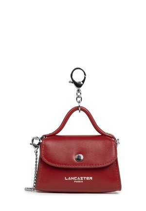 Red leather Lancaster Paris mini handbag keychain with silver clasp and chain, front button closure, and small top handle.