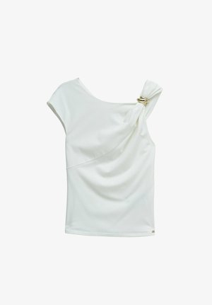 White sleeveless asymmetrical top with gold ring detail on one shoulder and draped fabric across the chest.