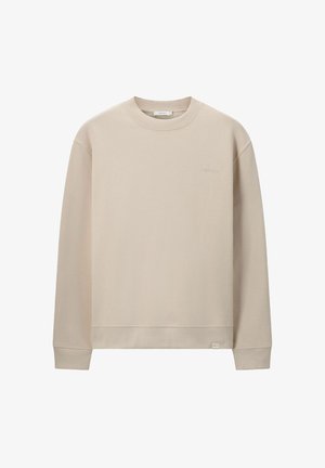 Beige crew neck sweatshirt made of soft material, featuring long sleeves, a relaxed fit, and subtle logo embroidery at the chest.