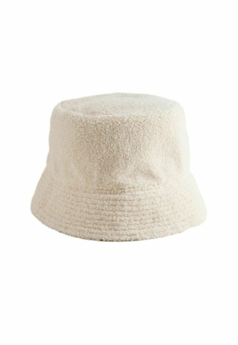 Cream-colored bucket hat made of textured fabric with a soft, plush feel. Features a rounded crown and a wide, downward-sloping brim.
