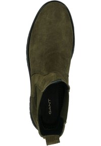 Olive green suede Chelsea boot with black sole, elastic side panels, rear pull tab, and "GANT" branding on the insole.