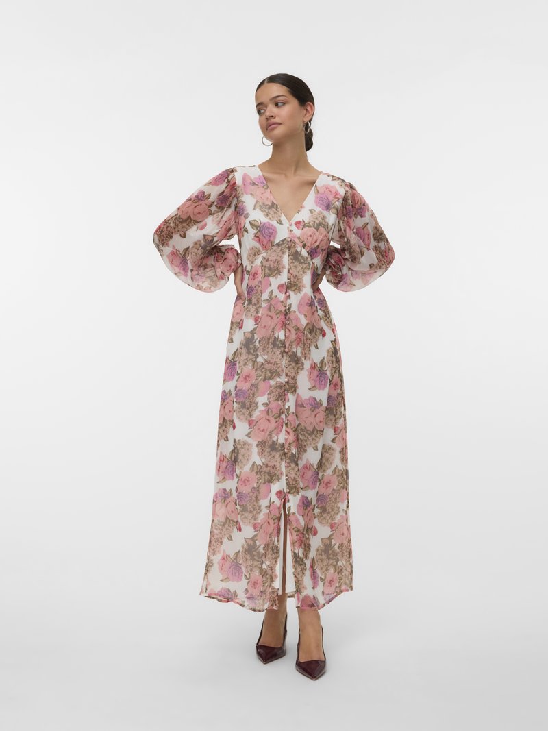 Bloemen maxi-jurk met roze en bruine rozenpatronen, doorschijnende stof, V-hals en pofmouwen. Bevat een split aan de voorkant en een vloeiende silhoette.