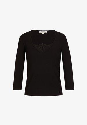 Musta pitkähihaisuus paita, jossa on V-pääntie ja pitsidetaili kaula-aukossa. Siinä on ribbitekstuuri ja pieni logotulostus helman lähellä.
