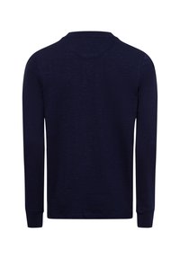 Navy blue long-sleeve shirt made of textured fabric, featuring a round neck and fitted cuffs, with a simple, unembellished design.