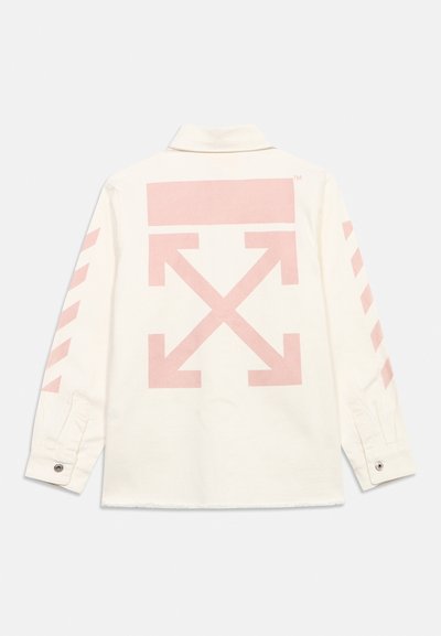 Chemise blanche à manches longues avec un grand motif flèche rose pâle au dos et des rayures diagonales sur les manches, dotée de poignets à boutons.