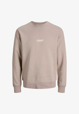 Lichtbeige sweatshirt met lange mouwen, ronde hals en geribde manchetten. Beschikt over een klein wit logo op de borst. Zachte, gladde textuur.