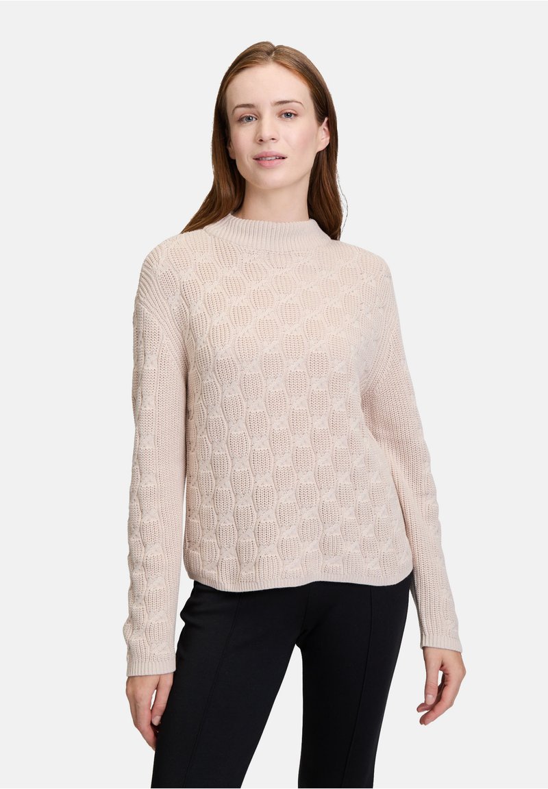 Helles rosa gestricktes Sweater mit einem strukturierten Muster, hohem Kragen und langen Ärmeln. Hergestellt aus weichem Material hat es eine lockere Passform.