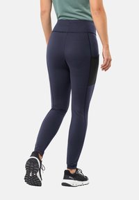 Marine leggings met een hoge tailleband, een soepele stof, een zijzak in het zwart en een taps toelopend ontwerp, ideaal voor sportkleding.