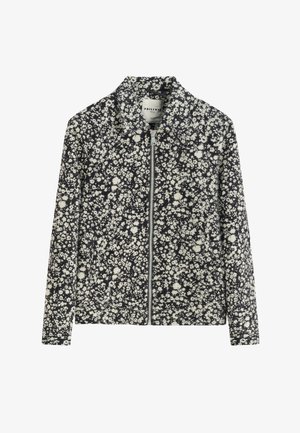 Veste zippée à imprimé floral noir et blanc avec manches longues et col montant, étiquetée Frillivin Parisian, étalée à plat sur fond blanc.