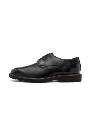 Zapato de vestir de cuero negro con punta redondeada, diseño con cordones y suela texturizada. Presenta un upper suave y acentos de costura mínimos.