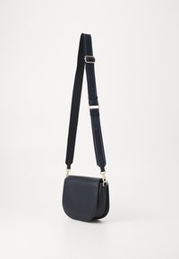 Tommy Hilfiger LOGOTAPE SADDLE BAG - Cross body bag - blue