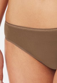 Brown bikini bottom made of smooth, stretchy fabric. Features a simple design with a mid-rise cut and a flat waistband for comfort.