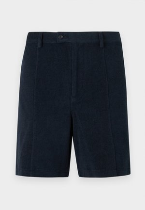 Short bleu marine taillé avec passants de ceinture, fermeture à boutons devant et ourlet droit sur un fond uni.