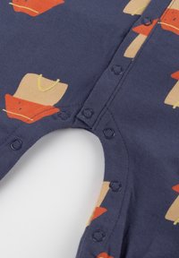 Navy cotton romper with orange hat and beige accents pattern. Features snap buttons along the side for easy dressing. Soft texture.