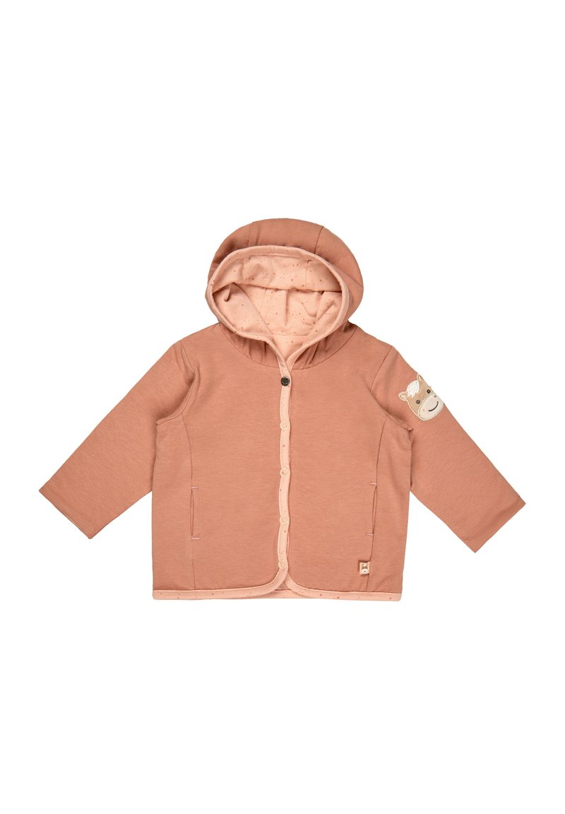 Pale pink hoodie with a lined hood, front pockets, snap fastenings, and a bear patch on the sleeve. Soft fabric, relaxed fit.