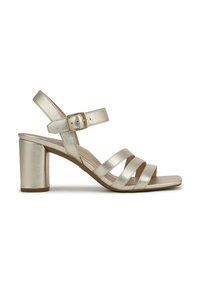 Metallic gold heeled sandal with three wide straps and an adjustable ankle strap. Features a chunky block heel and smooth texture.