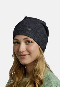 Dark gray knitted beanie with a soft texture, featuring a round Buff logo patch on the front. The hat is close-fitting and slouched.