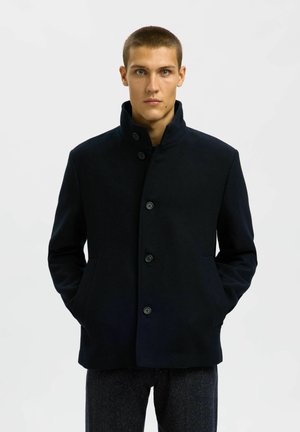 Chaqueta negra de mezcla de lana para hombre con cuello alto, cierre de botones en la parte delantera y dos bolsillos laterales. Textura suave con un diseño estructurado.