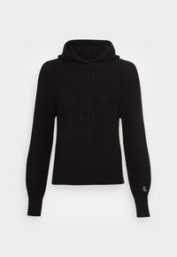 Czarna dzianinowa bluza z kapturem o prążkowanej fakturze, z kapturem ze sznurkiem i długimi rękawami. Na lewym rękawie znajduje się małe logo.